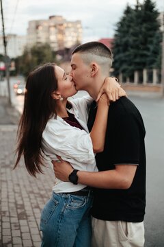 Young couple kissing embracing on city street
