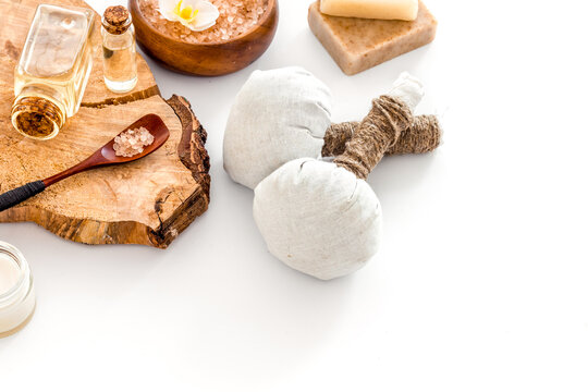 Massage thai herbal balls near spa accessories on white background space for text