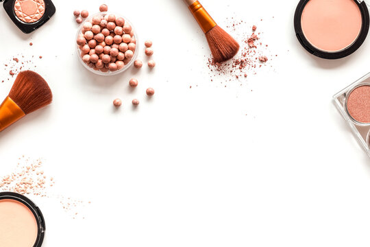 Makeup concept. Frame with decorative cosmetics and brushes on white background top view copy space