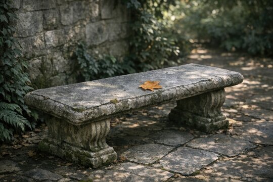 A simple stone bench with a single leaf on top, ideal for using in illustrations or as a decorative element