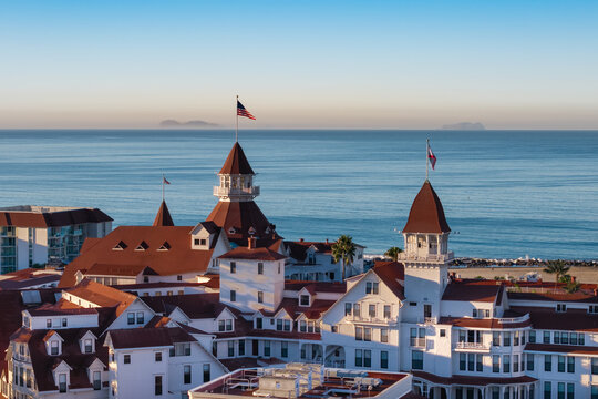 Coronado, California, United States - 10 September 2025: Aerial view of Hotel del Coronado with its iconic red turrets and white architecture along the Pacific coastline.