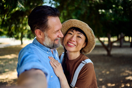 Happy Couple Selfie in Park &mdash; Asian Woman and Man Smiling Together on Sunny Day