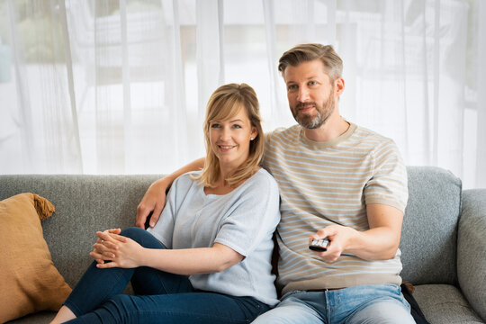 Mature couple at home watching TV and spending relaxed day together