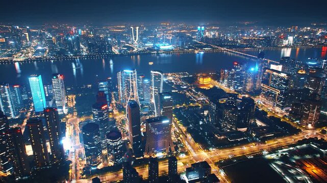  Aerial twilight skyline of Hangzhou Qianjiang New Town, illuminated modern skyscrapers and Grand Theater, city lights reflect on Qiantang river