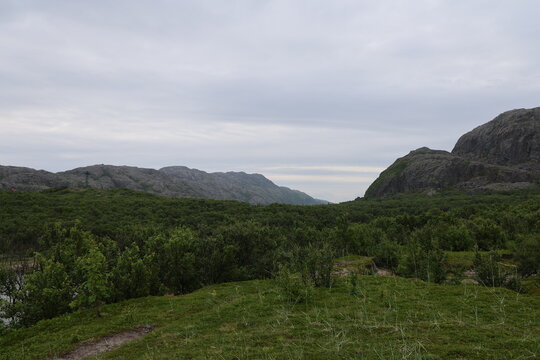 Mountain landscape showing Norwegian and Russian wilderness separated by the Jakobselv River near the border.