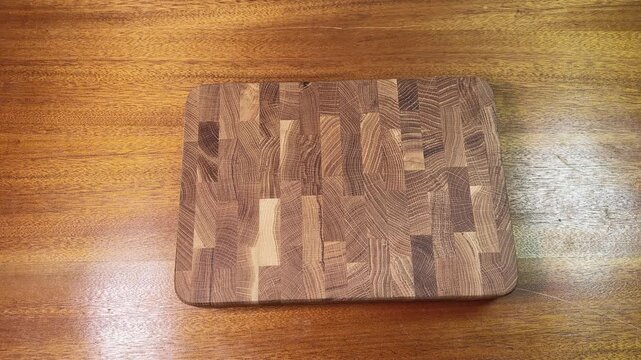 Stacking different natural oak and bamboo cutting boards on table