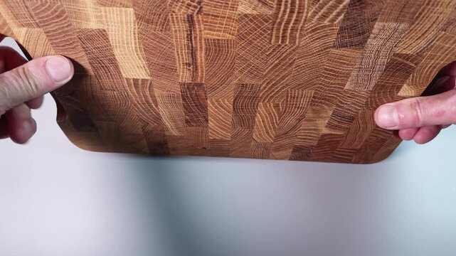 Demonstration of oak end grain cutting board in hands