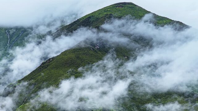 Aerial view of the summer landscape in Shuangqiao Valley Scenic Area of Mount Siguniang, Aba Prefecture, Sichuan, China, with mist-shrouded mountains