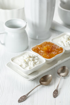 Curd dessert with cream and apricot jam.