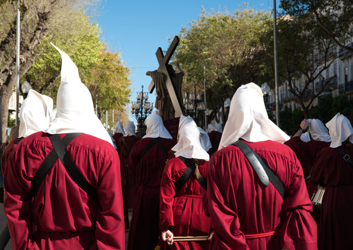 A Holy Week procession in Spain featuring a local religious brotherhood with hooded penitents and a float bearing religious images, which has been designated a site of international tourist interest.	