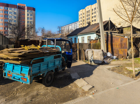 Blue Three-Wheeled Utility Vehicle with Cardboard Boxes in Kyrgyzstan