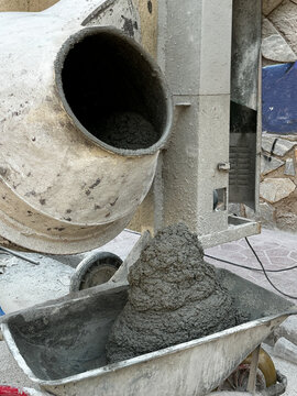 Mobile concrete mixer preparing construction mixture. Closeup.