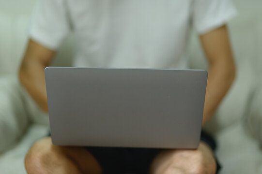 Person Using Laptop in Cozy Indoor Setting for Work or Study
