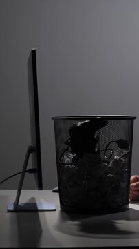 Vertical video person breaking a gaming habit by disposing of their controller into a bin, symbolizing overcoming addiction, discipline, and seeking a healthier lifestyle away from screen time