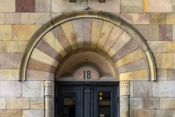 Fototapeta premium Stockholm building entrance showing arched stone doorway number 18