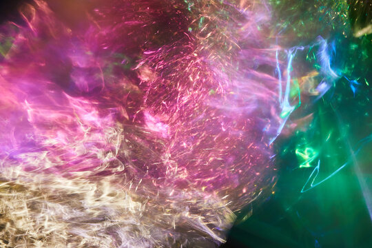 Abstract light streams blurring and blending colors, creating vibrant pink, green, and yellow energy motion