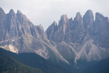 Obraz premium Majestic scenery of rough mountain ridge near grassy hills 