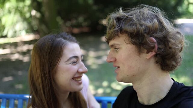 Young couple laugh and flirt while getting to know each other outdoors as mutual attraction grows into romance showing chemistry joy affection and new love beginning soon