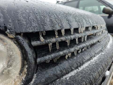 Frozen Car Grille with Icicles on Overcast Day