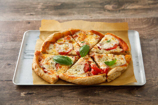 Homemade pizza with tomatoes and mozzarella cheese