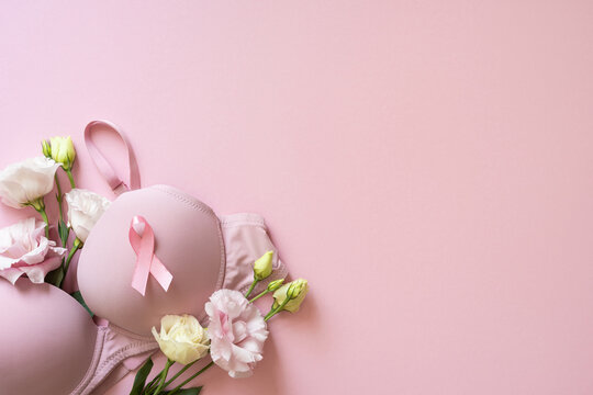 Pink bra with ribbon and flowers on soft banner pink background for Breast Cancer Awareness Month campaign