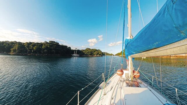 Family sailing on the small sailing boat in Brazil