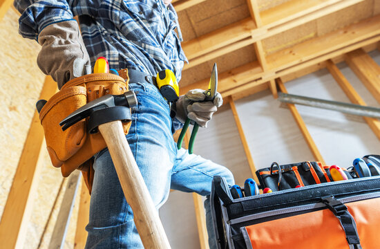 Construction worker prepares tools in a workshop for a building project