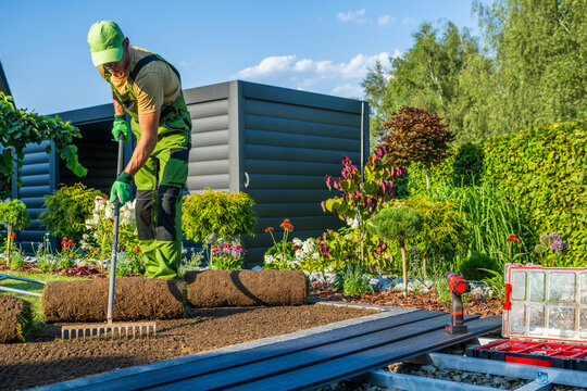 Gardener working on lawn installation in a backyard setting