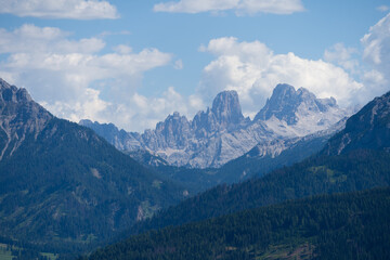Obraz premium Majestic scenery of rough mountain ridge near grassy hills 