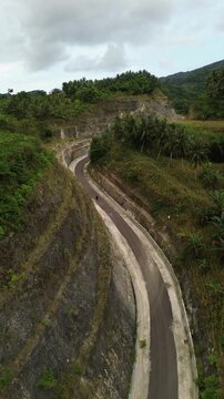 Aerial View of Winding Road Through Mountainous Terrain