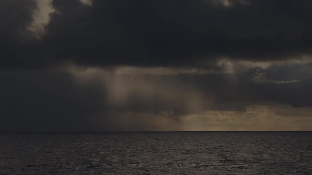 Dark Atlantic Ocean and stormy clouds as seen from the moving sailing boat