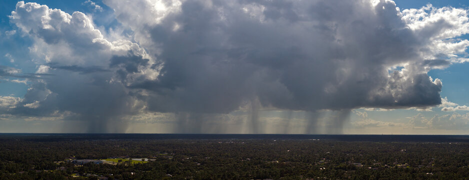Rain shower water pouring down from stormy clouds during summer thunderstorm in Florida