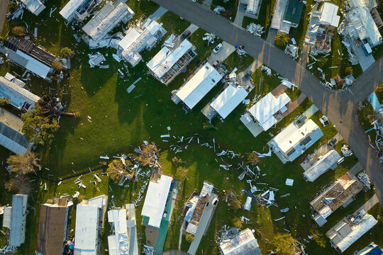 Severely damaged by hurricane Ian houses in Florida mobile home residential area. Consequences of natural disaster
