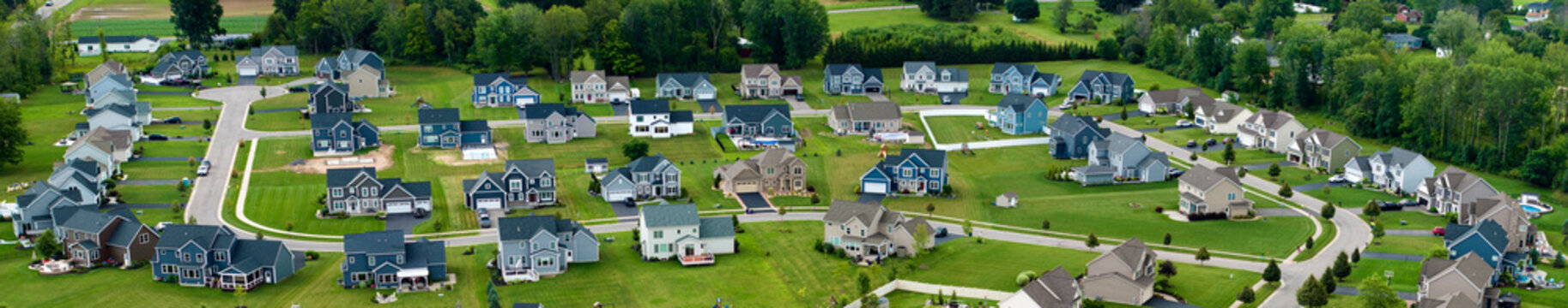 View from above of residential houses in living area in Rochester, NY. American dream homes as example of real estate development in US suburbs