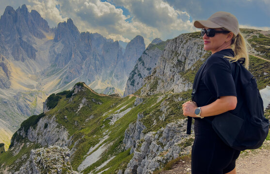 Young woman exploring hiking trail in Dolomites near Tre Cime Dolomites Italy