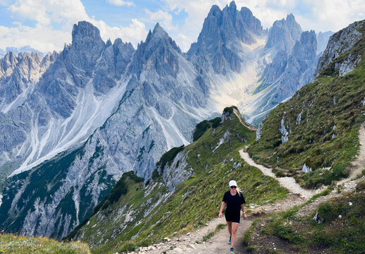 Dramatic rocky mountain peaks of the Cadini di Misurina under a moody sky with large cumulus clouds, high-altitude alpine wilderness landscape asset 