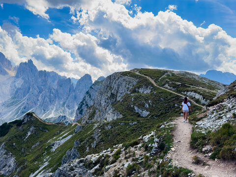 Dramatic rocky mountain peaks of the Cadini di Misurina under a moody sky with large cumulus clouds, high-altitude alpine wilderness landscape asset 