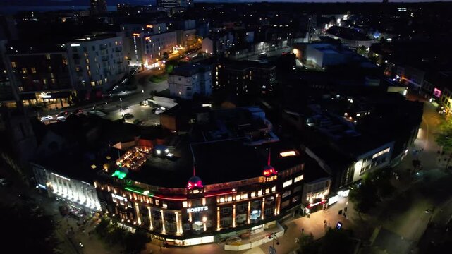 High Angle Night Footage of Illuminated Buildings and Roads with Traffic at Best Tourist Attraction Destination of England at Bournemouth City with Sandy Beach and Ocean of Great Britain, 