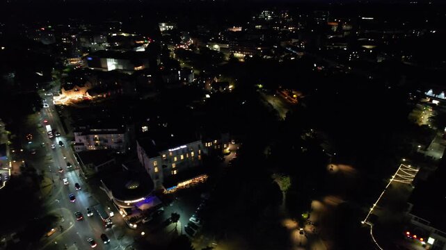 High Angle Night Footage of Illuminated Buildings and Roads with Traffic at Best Tourist Attraction Destination of England at Bournemouth City with Sandy Beach and Ocean of Great Britain, 