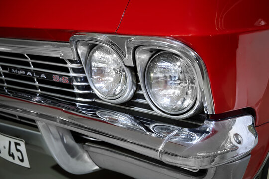 A detailed view of the front corner of the classic 1963 Chevrolet Impala SS convertible, highlighting the round headlights.