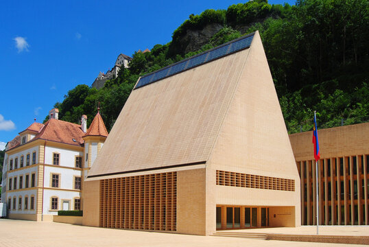Vaduz, Liechtenstein &ndash; July 14, 2014. The Parliament building in Vaduz. View with surrounding buildings, in summer.