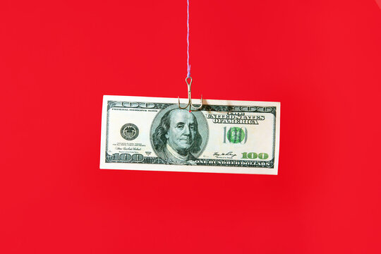 Dollar bill on hook over red background