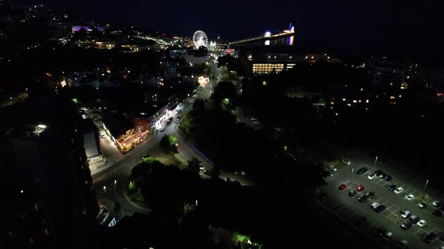 High Angle Night Footage of Illuminated Buildings and Roads with Traffic at Best Tourist Attraction Destination of England at Bournemouth City with Sandy Beach and Ocean of Great Britain, 