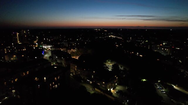High Angle Night Footage of Illuminated Buildings and Roads with Traffic at Best Tourist Attraction Destination of England at Bournemouth City with Sandy Beach and Ocean of Great Britain, 