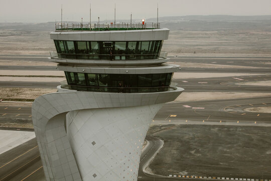 Arnavutkoy, Turkiye - 06 April 2019: Aerial view of Istanbul Airport control tower with its distinctive tulip-shaped architecture rising above the surrounding runways and tarmac.