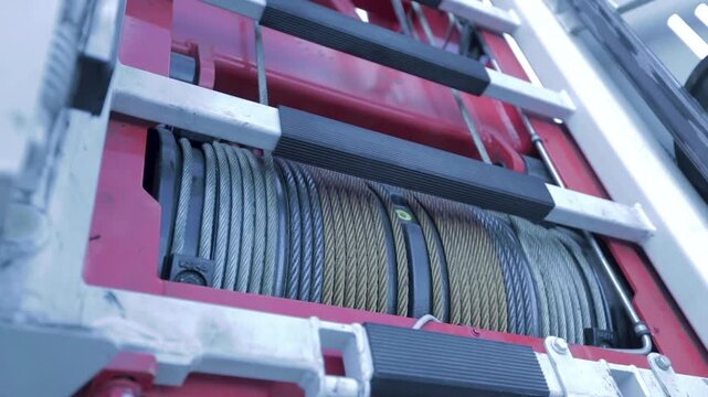 Close-up of a moving steel cable winch on a German fire department aerial ladder truck