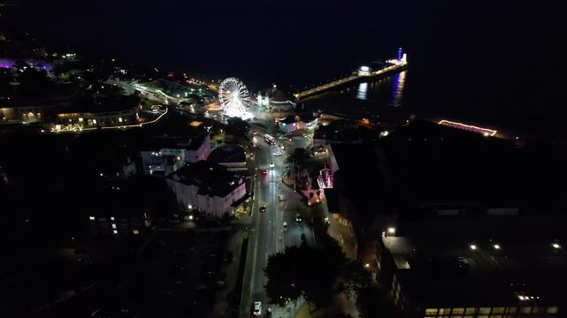 High Angle Night Footage of Illuminated Buildings and Roads with Traffic at Best Tourist Attraction Destination of England at Bournemouth City with Sandy Beach and Ocean of Great Britain, 
