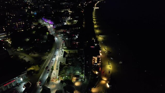 High Angle Night Footage of Illuminated Buildings and Roads with Traffic at Best Tourist Attraction Destination of England at Bournemouth City with Sandy Beach and Ocean of Great Britain, 