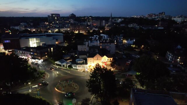High Angle Night Footage of Illuminated Buildings and Roads with Traffic at Best Tourist Attraction Destination of England at Bournemouth City with Sandy Beach and Ocean of Great Britain, 