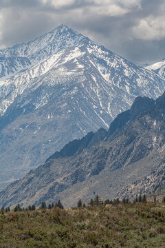 Vertical closeup view of a majestic snow-capped mountain peak in Sierra Nevada
